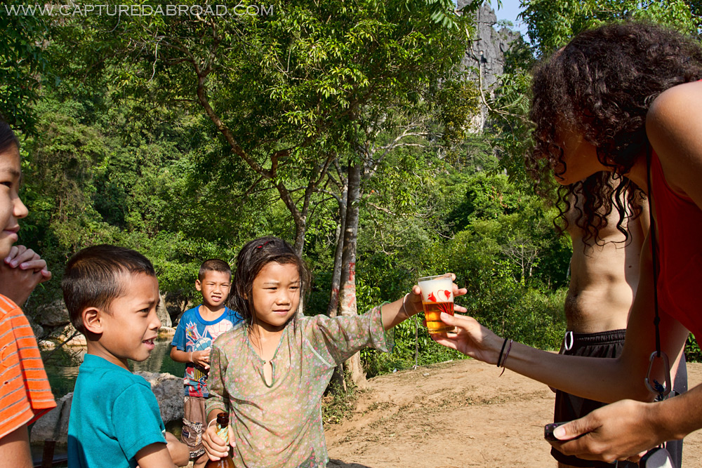 Kid serving Beer Laos in Bo Houay Namgen on the "Thakhek loop"