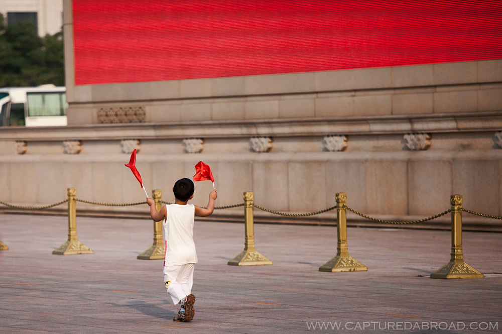 Kid waving the Chinese flag at Tiananmen square