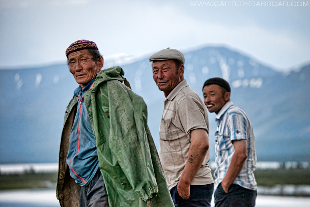 Three Kazak-mongol men walk along the Khurgan Nuur