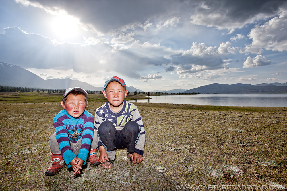 Curious kids observing me eat by the Khurgan Nuur Mongolia, sunset