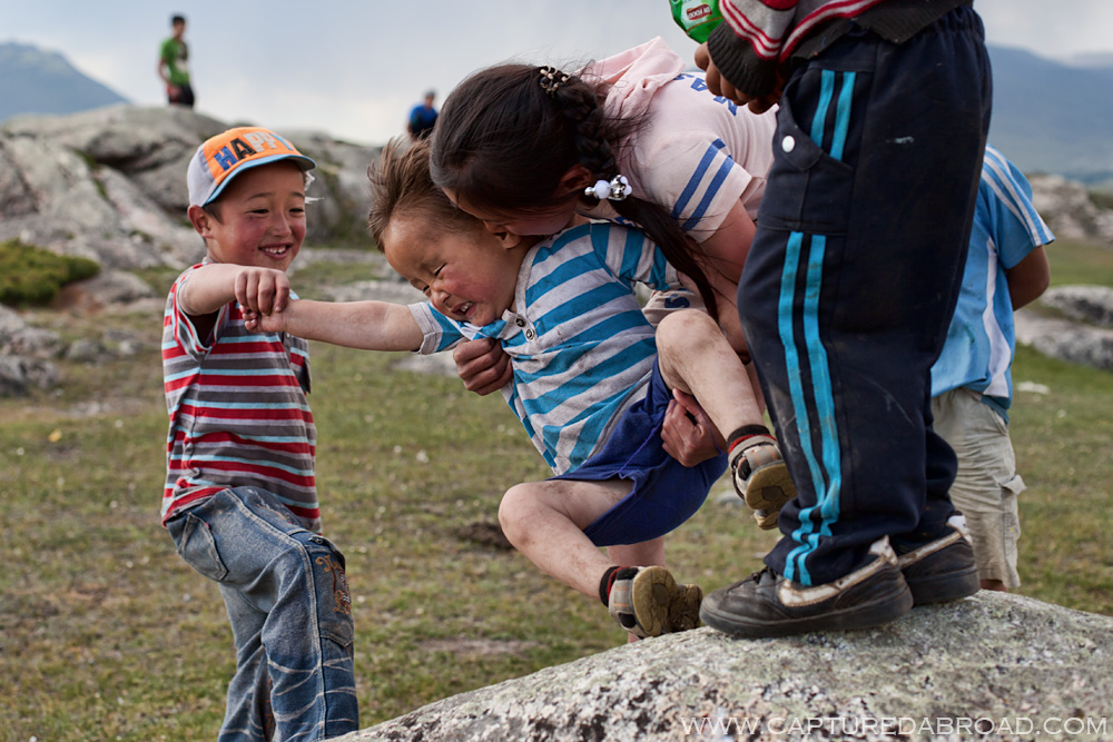 Mongol kazak kids playing at khurgan nuur mongolia