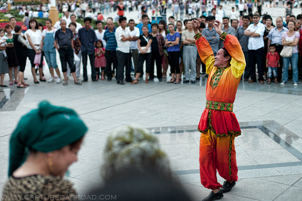 China, Xingjiang province, ethnic Uyghur man dancing in square