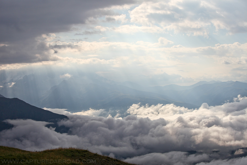 Beautiful light show between clouds from Lake Koruldi, Mestia